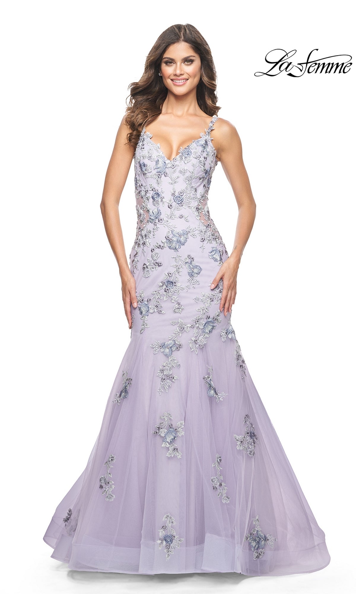 A woman poses against a white background in the La Femme Long Lavender Mermaid Prom Dress 32091, featuring floral embroidery. The La Femme logo is displayed in the top right corner.